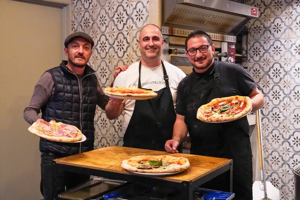 Antonio, Salvatore and Francesco with their Neapolitan pizzas at BROS in Ixelles
